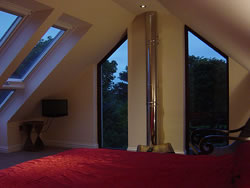 The master bedroom has windows which look out upon the St Magnus Cathedral spire